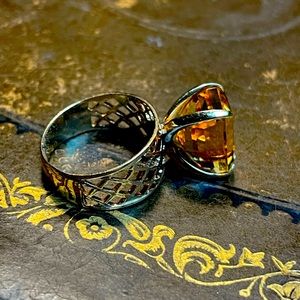 Vintage ring, gold basket weave wide band and enormous golden colored stone.